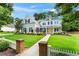 Charming two-story home with landscaped yard, inviting entrance, and well-manicured lawn on a sunny day at 4115 Williams Point Dr, Cumming, GA 30028