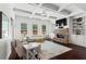Inviting living room featuring a stone fireplace, coffered ceiling, built-in shelving, and hardwood floors at 4115 Williams Point Dr, Cumming, GA 30028
