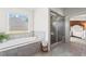 Bright main bathroom showcases a soaking tub and a separate glass shower, designed for relaxation at 4115 Williams Point Dr, Cumming, GA 30028