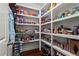 Walk-in pantry with ample shelving, perfect for organized storage at 4115 Williams Point Dr, Cumming, GA 30028