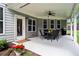 Covered patio with outdoor seating, ceiling fan, and views of the backyard at 4115 Williams Point Dr, Cumming, GA 30028