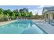 Outdoor community pool with lounge chairs and a pergola shaded dining area for residents at 4115 Williams Point Dr, Cumming, GA 30028
