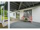 Covered back porch offering outdoor seating and access to the backyard at 4914 Watson Mill Ct, Loganville, GA 30052