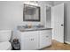 Bathroom featuring a double sink vanity with granite countertops and wood look floors at 4914 Watson Mill Ct, Loganville, GA 30052