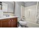 Bathroom with wood cabinet vanity, toilet and bathtub at 4914 Watson Mill Ct, Loganville, GA 30052