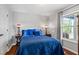 Bedroom featuring wood-look floors and natural light from the window with curtains at 4914 Watson Mill Ct, Loganville, GA 30052