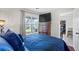 Cozy bedroom featuring a large window, TV, and a comfortable blue comforter at 4914 Watson Mill Ct, Loganville, GA 30052