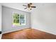Bedroom with hardwood floors and large window view of outside at 4914 Watson Mill Ct, Loganville, GA 30052