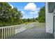 Grey wooden deck overlooking large backyard with lush lawn and mature trees at 4914 Watson Mill Ct, Loganville, GA 30052