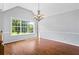 Bright dining area with hardwood flooring, chandelier, and large window offering natural light at 4914 Watson Mill Ct, Loganville, GA 30052