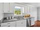 Bright kitchen featuring white cabinets and granite countertops with stainless steel appliances at 4914 Watson Mill Ct, Loganville, GA 30052