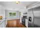 Bright kitchen featuring white cabinets and stainless steel appliances and window view to backyard at 4914 Watson Mill Ct, Loganville, GA 30052