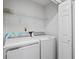 Well-lit laundry area with both a washing machine and a dryer for convenient laundry tasks at 4914 Watson Mill Ct, Loganville, GA 30052