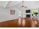 Open living room features a fireplace, hardwood flooring, and plenty of natural light at 4914 Watson Mill Ct, Loganville, GA 30052