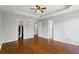 Main bedroom with tray ceiling, hardwood floors, and walk-in closet at 4914 Watson Mill Ct, Loganville, GA 30052