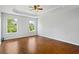 Main bedroom with tray ceiling, hardwood floors, and large window views of outside at 4914 Watson Mill Ct, Loganville, GA 30052