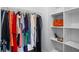 Walk-in closet with metal hanging racks and built-in shelving for optimal storage at 4914 Watson Mill Ct, Loganville, GA 30052