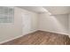 Basement featuring wood-look floors and a white exterior door at 1034 Sandy Ridge Rd, Mcdonough, GA 30252