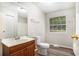 Cozy bathroom featuring a classic vanity, toilet, and shower, offering a functional and clean design at 1034 Sandy Ridge Rd, Mcdonough, GA 30252