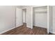Bedroom featuring wood-look floors and a closet with white doors at 1034 Sandy Ridge Rd, Mcdonough, GA 30252