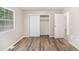 Bedroom featuring wood-look floors and a closet with white doors at 1034 Sandy Ridge Rd, Mcdonough, GA 30252