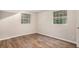 Bedroom featuring wood-look floors, neutral walls, and natural light from two windows at 1034 Sandy Ridge Rd, Mcdonough, GA 30252