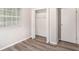 Bedroom featuring wood-look floors and a closet with white doors at 1034 Sandy Ridge Rd, Mcdonough, GA 30252