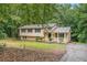 Charming two-story home with a cozy covered porch and a well-maintained lawn surrounded by mature trees at 1034 Sandy Ridge Rd, Mcdonough, GA 30252