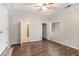Bright main bedroom with wood-look flooring, neutral walls, ceiling fan, and attached bathroom with tile floors at 1034 Sandy Ridge Rd, Mcdonough, GA 30252