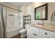 Bright bathroom featuring a tub/shower combo, granite vanity, and modern fixtures at 6375 Eidson Dr, Cumming, GA 30041