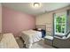 Comfortable bedroom featuring neutral carpet, a twin bed, and a bright window at 6375 Eidson Dr, Cumming, GA 30041