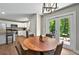 Dining area is adjacent to the kitchen and features wood table and glass panel doors to the patio at 6375 Eidson Dr, Cumming, GA 30041