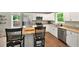 This kitchen features granite countertops, stainless steel appliances and a view to the wooded backyard at 6375 Eidson Dr, Cumming, GA 30041