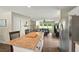 Open-concept kitchen with stainless steel appliances and granite countertops overlooks the living room at 6375 Eidson Dr, Cumming, GA 30041