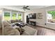 Comfortable living area with a plush sectional couch, sleek flooring, and bright natural light at 6375 Eidson Dr, Cumming, GA 30041