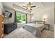 Spacious main bedroom with neutral colors and a view of the wooded backyard at 6375 Eidson Dr, Cumming, GA 30041