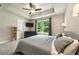 The main bedroom features a tray ceiling, TV, and wooded backyard view at 6375 Eidson Dr, Cumming, GA 30041