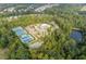 Aerial view of community amenities including a swimming pool, clubhouse, tennis courts, and a basketball court at 6585 Canyon Cv, Cumming, GA 30028