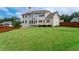 Expansive backyard featuring lush green lawn and privacy fence at 6585 Canyon Cv, Cumming, GA 30028