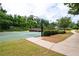 Well-maintained basketball court with lush landscaping and walking path in a vibrant community setting at 6585 Canyon Cv, Cumming, GA 30028