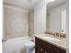 Bathroom featuring tile, vanity and a tub at 6585 Canyon Cv, Cumming, GA 30028