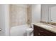 Bathroom with granite counters, tile shower, and tile flooring at 6585 Canyon Cv, Cumming, GA 30028