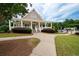 Charming clubhouse with welcoming entrance, covered porch, and well-manicured landscaping at 6585 Canyon Cv, Cumming, GA 30028