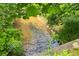 A tranquil creek flows through the lush greenery of the Parkstone community, adding a touch of nature at 6585 Canyon Cv, Cumming, GA 30028