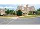 Beautiful clubhouse exterior with inviting porches and manicured landscaping, set in a vibrant community at 6585 Canyon Cv, Cumming, GA 30028