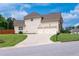 Charming two-story home with a well-manicured lawn, long driveway, and three-car garage at 6585 Canyon Cv, Cumming, GA 30028