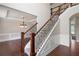 Open foyer with hardwood floors, staircase, and elegant trim details, adjacent to the dining room at 6585 Canyon Cv, Cumming, GA 30028
