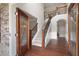 Grand foyer with a staircase, hardwood floors, and stone accent wall detail at 6585 Canyon Cv, Cumming, GA 30028