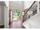 Spacious foyer featuring soaring ceilings and a view of the front yard through double doors at 6585 Canyon Cv, Cumming, GA 30028