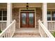 Elegant, decorative front door flanked by sidelights, providing a warm welcome at 6585 Canyon Cv, Cumming, GA 30028